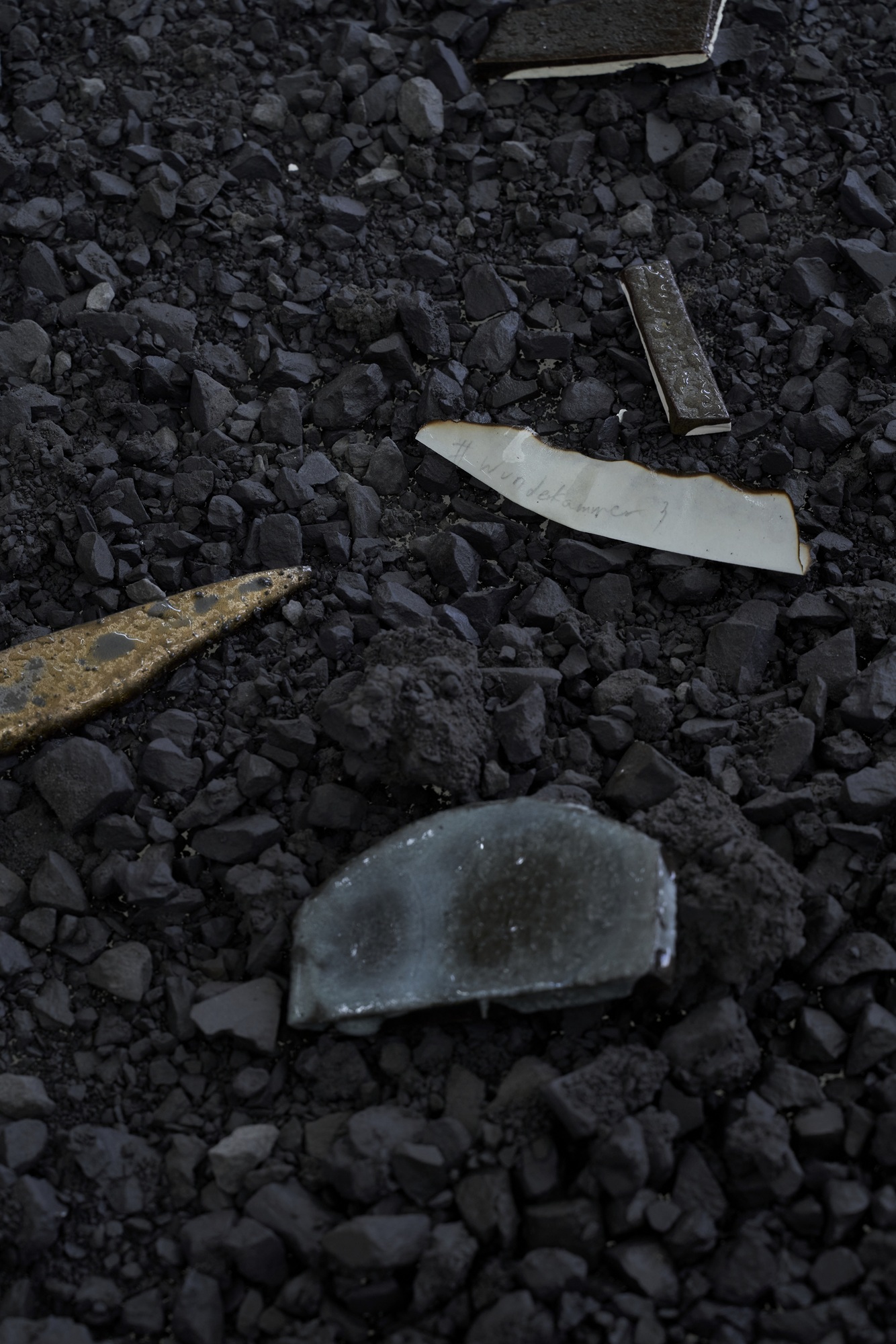 #15, 2026, glazed and unglazed black clay, glazed modeling clay, glass, burned paper, 250 x 250 x 73cm