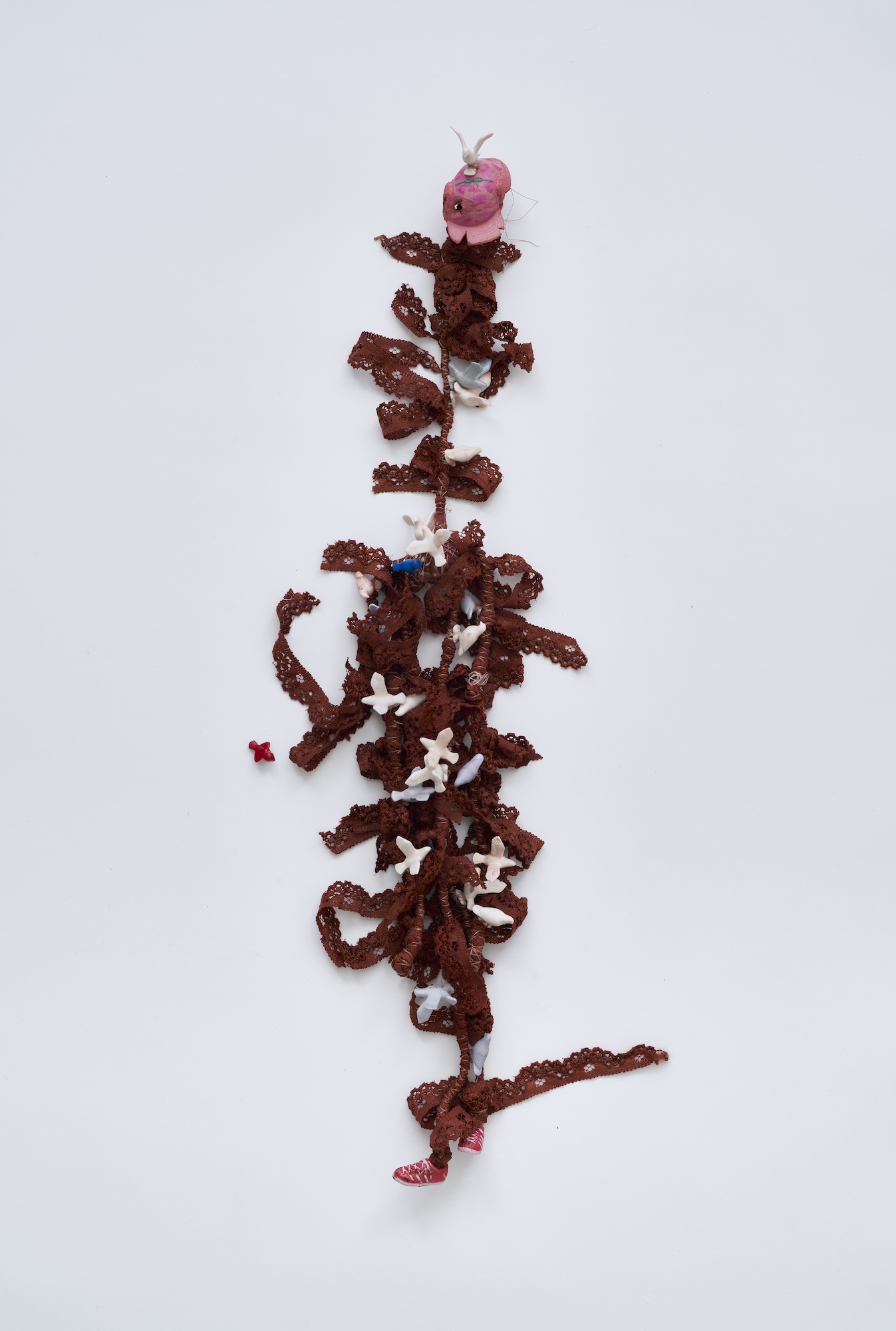Flower 12, 2026, Wire, cord, thread, pigment, fabric, found objects, dolls, miniatures, 10x58x8cm
